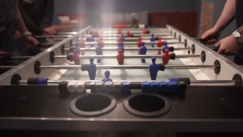 Group of young people playing table soccer in the bar Stock Footage 71066199