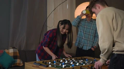 Group Of Young People Playing Table Soccer at the Home Party Stock Footage 150290137