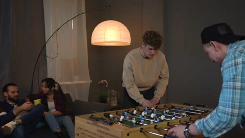 Group of Young People Playing Table Kicker. Man Is Angry about Missing the Goal. Stock Footage 150290623