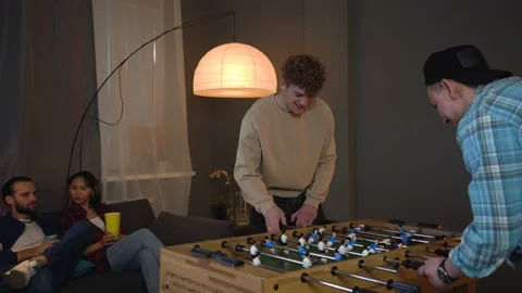Group of Young People Playing Table Soccer. Man Is Happy about Scoring the goal. Stock Footage 150290631