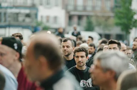 Group of young people queue in front of Apple Store with custome Stock Photos