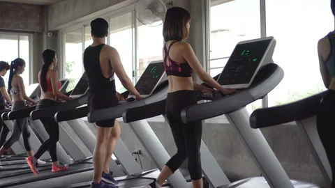 Group of young people running on treadmills in sport gym .fitness woman runne Stock Footage 112277591