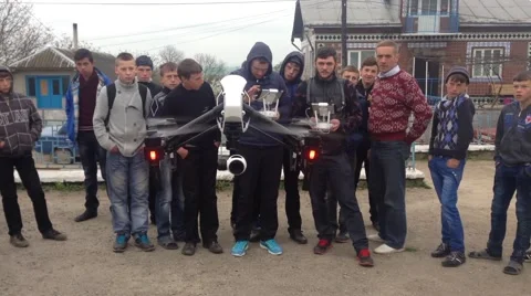 A group of young people start the copter with remote control Stock Footage 62779768
