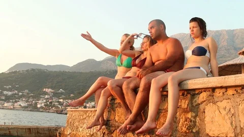Group Of Young People Talking And Having Fun In A Beach Bar Stock Footage 99064587