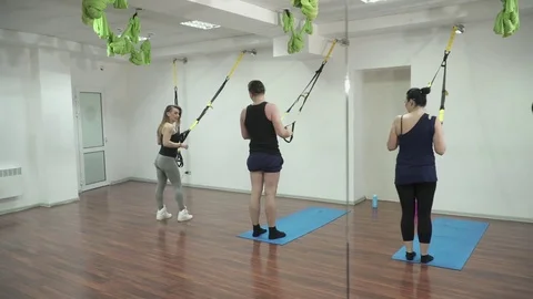 Group of young people training with TRX Stock Footage
