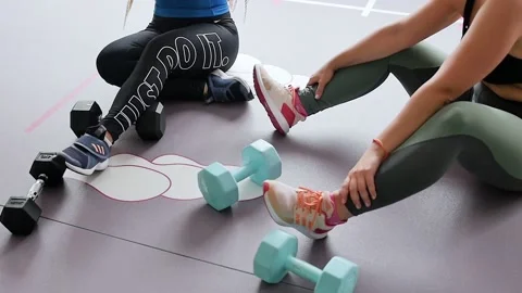 Group of young pretty women doing fitness indoors. Doing sports in a fitness Stock Footage 130660237