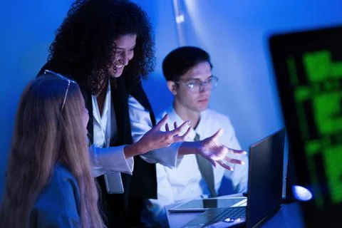 Group of young professionals collaborating on technology project in modern .. Stock Photos