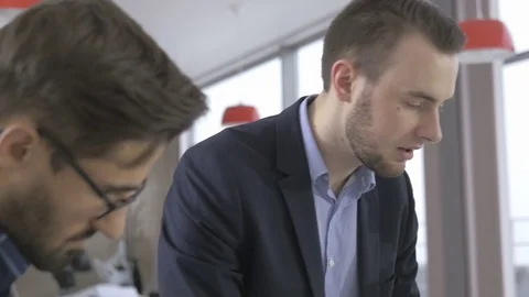 Group of young professionals discussing in the modern office Stock Footage 73992772