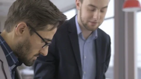 Group of young professionals discussing in the modern office Stock Footage 73993111