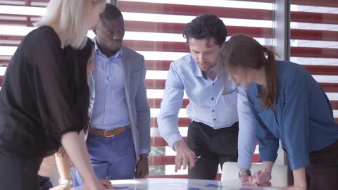 Group of young professionals talking about the world economy Stock Footage 73864900