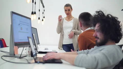 Group of young programmers in casualwear looking at coded data on computer sc Stock Footage 142329873