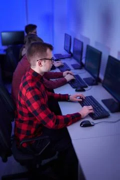 A group of young programmers work in an office at a computer. Stock-Fotos