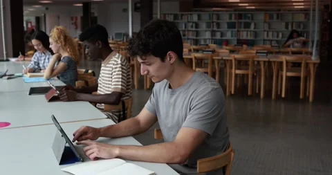 Group of young students learing together inside school library Stock Footage 203720901