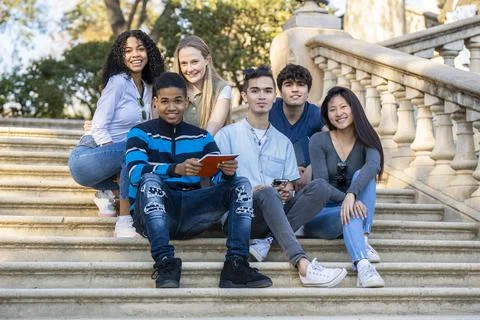 Group of young students looking to the camera on some stairs Stock Photos