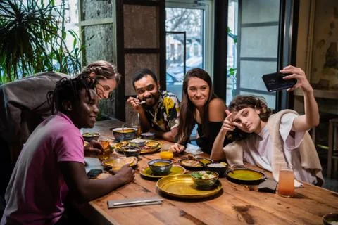 Group of young students making funny faces, taking photos with t Stock Photos