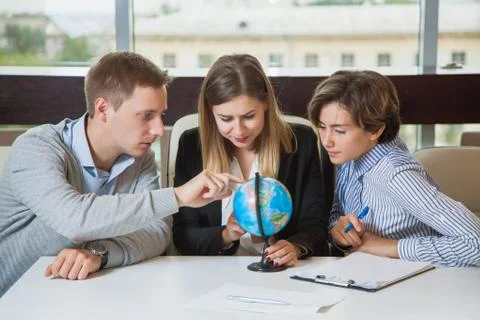 Group of young students study globe search for travel country Stockfoto's