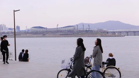 Group of young students walk together along Han river, Seoul, South Korea Stock Footage 94084047
