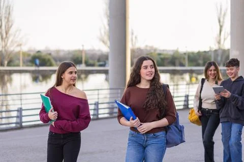 Group of young students walking together on campus Stock Photos