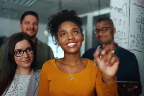 Group of young successful creative multiethnic team smiling and working together Stock Photos