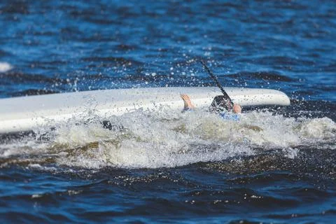 Group of young sup surfers fall from SUP stand up paddle board, women drownin 스톡 사진
