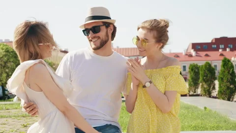 Group of young three stylish friends posing in the street Stock Footage 142299554
