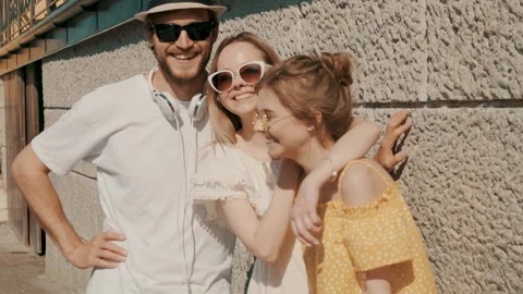 Group of young three stylish friends posing in the street Stock Footage 142299792