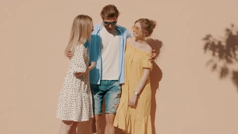 Group of young three stylish friends posing in the street Stock Footage 142301577