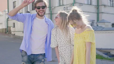 Group of young three stylish friends posing in the street Stock Footage 142302766