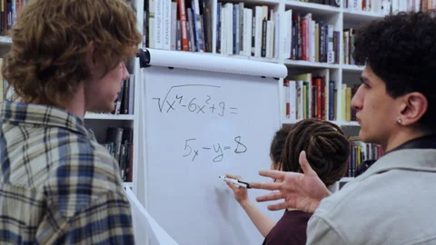 Group of Young University Students Collaborating on a Difficult Math Equation in 스톡 동영상 335139484