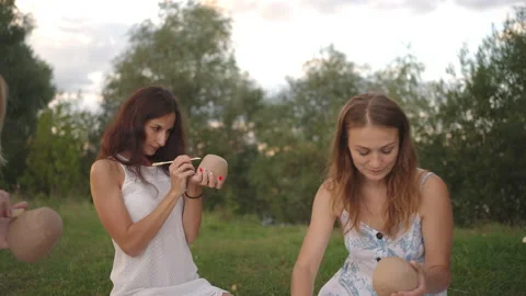 A group of young women apply patterns on clay products, decorate them with tools Stock Footage 160910515