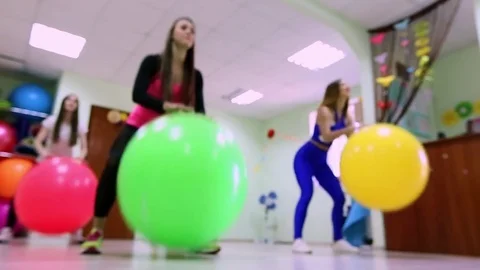 A group of young women doing exercises with fitballs in a fitness club. Healthy Video stock 75446363