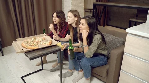 Group of young women drinking beer emotionally rooting for their favorite team Stock Footage 129487576