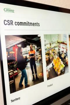 Groupe casino csr commitments shown on lap.. Stock Photos