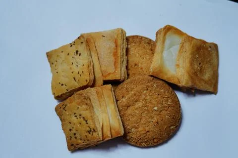 Grouping baked snacks including crispy khari biscuits topped with cumin seeds 스톡 사진
