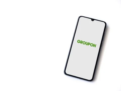 Groupon app launch screen with logo on the display of a black mobile smartpho Stock Photos