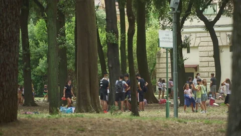 Groups of children playing at the summer camps in the park of Villa Torlonia Stock Footage 157670213