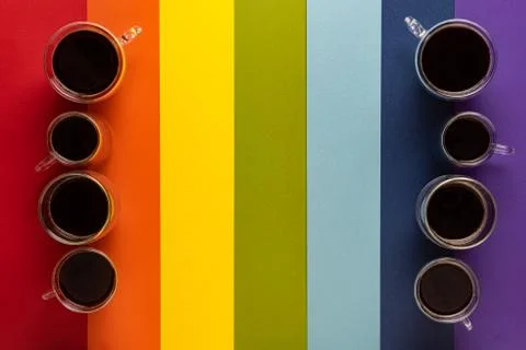 Groups of cups with coffee on rainbow background Stock Photos