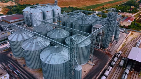 Groups of metal tanks for grain storage. Top view on the railways with trains Stock Footage 340360168