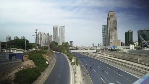 Groups of people with bicycles ride on empty highway during Yom Kippur In Israel Stock Footage 102677388