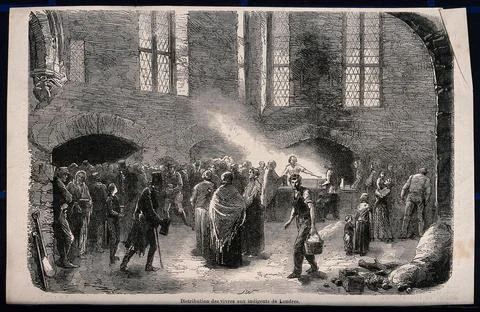 Groups of people stand around while others are being handed food at a table.. Ilustração Stock