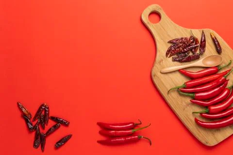 Groups of red chilli peppers and dried asian hot capsicum on the wooden chopp Stock Photos