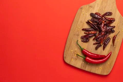 Groups of red chilli peppers and dried chinese hot capsicum on the wooden Stock Photos