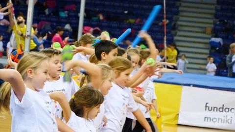 Groups of school children throwing foam darts then chasing after them Stock Footage 103684845