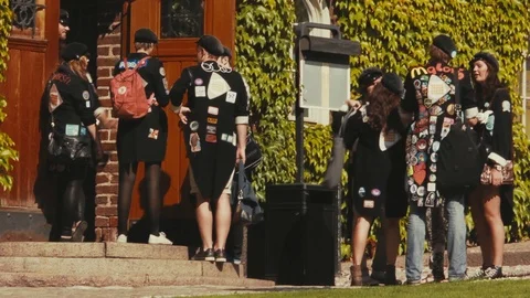 Groups of students in black jackets covered with patches and wearing Stock Footage 98475093