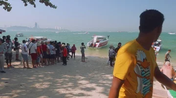 Groups of tourists waiting for their turn to get into speedboat for excursion Stock Footage 85471349