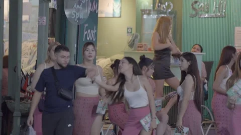 Groups of women trying to take men to pleasure them after a nightclub Stock Footage 306043067