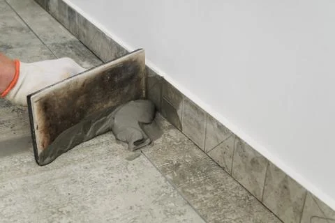 Grouting ceramic tiles. Stock Photos