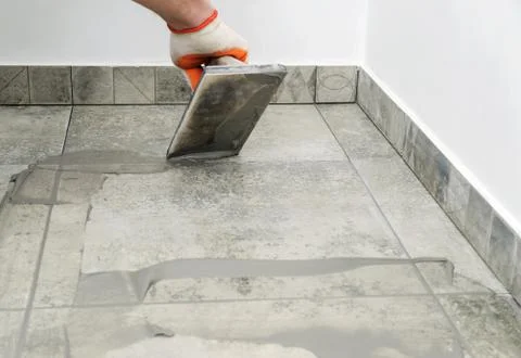 Grouting ceramic tiles. Stock Photos
