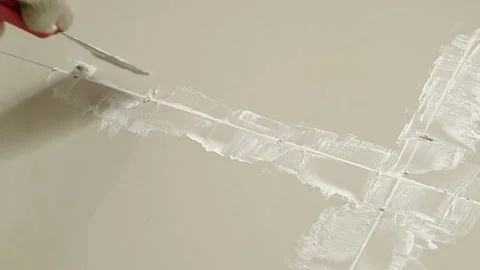 Grouting ceramic tiles. Tilers filling the space between tiles using a Stainless Stock Footage 171763384