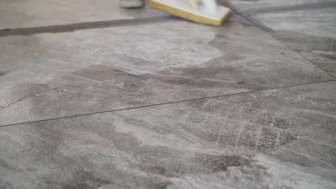 Grouting joints after laying large-format tiles on the floor. Stock Footage 275666344
